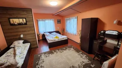 a room with two beds and a couch in it at Guest House PIP in Velingrad