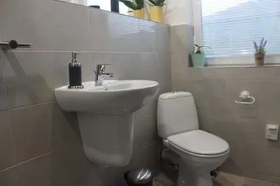 a bathroom with a white sink and a toilet at Apartments 18 in Velingrad