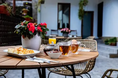 a wooden table with a plate of food and drinks at Velinov Boutique Hotel with Free Shuttle in Bansko