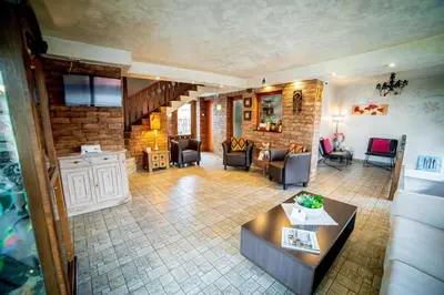 a living room with a couch and a table at Velinov Boutique Hotel with Free Shuttle in Bansko