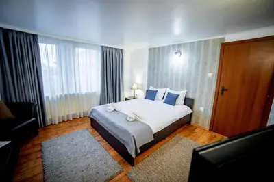 a hotel room with a bed and a large window at Velinov Boutique Hotel with Free Shuttle in Bansko