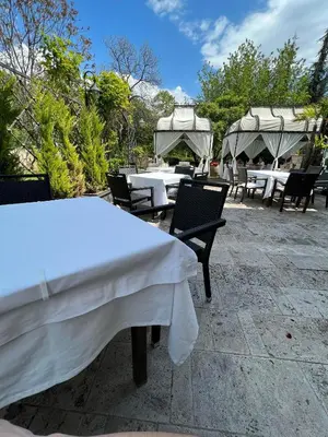 a group of tables and chairs with white table cloth at Park Hotel Sandanski in Sandanski
