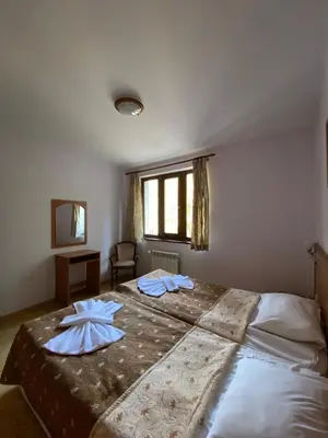 a bedroom with a large bed with two pillows on it at Villa Ibar in Borovets
