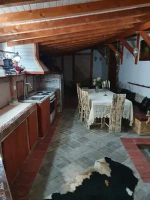 a kitchen and dining room with a table and chairs at Kashtata s Paraklisa in Borowo
