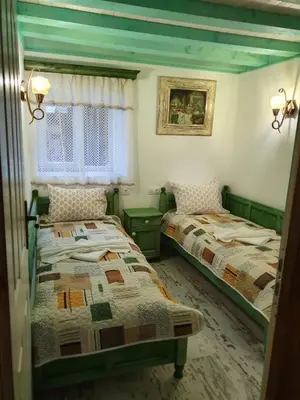 a bedroom with two beds and a window at Kashtata s Paraklisa in Borowo