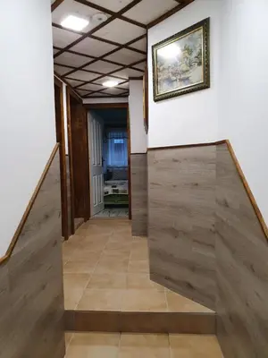 a hallway with wood floors and a painting on the wall at Kashtata s Paraklisa in Borowo