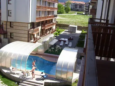 a woman is in a swimming pool in a building at Apartments Four Leaf Clover Bansko to rent in Bansko