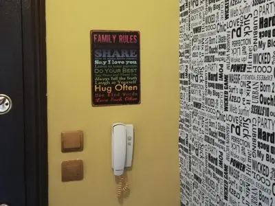 a phone on a wall with a sign on it at Business Park Apartment in Sofia