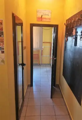 a hallway with a door with a sign that reads love at Business Park Apartment in Sofia