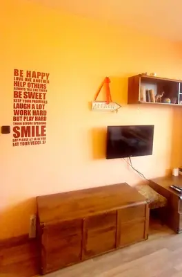 a living room with a flat screen tv on a wall at Business Park Apartment in Sofia