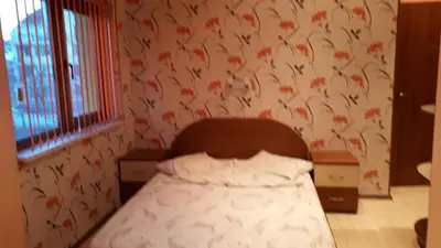 a bedroom with a bed with a floral wallpaper at Guest House Blisten in Sofia