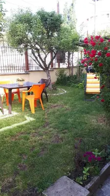 a picnic table and benches in a yard at Guest House Blisten in Sofia