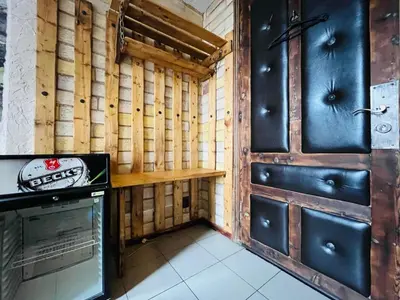 a room with wooden walls and a kitchen with a stove at Rooms43 in Sofia