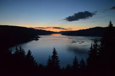 a view of a lake at sunset with trees at EldoSport Hotel in Dospat