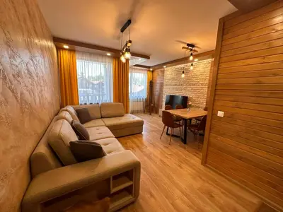 a living room with a couch and a table at Alpine luxury two bed-two bathrooms apartment B25 in Borovets