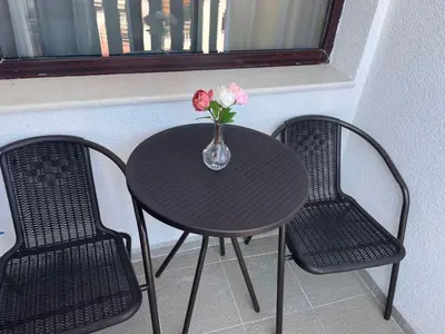 a black table with two chairs and a vase with flowers at Alpine luxury two bed-two bathrooms apartment B25 in Borovets