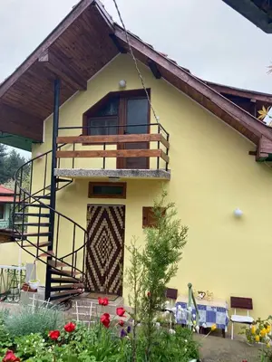 a house with a balcony on the side of it at Vila Venera in Velingrad