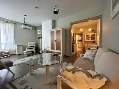 a living room with a couch and a glass table at The Bookies Apartments in Sofia