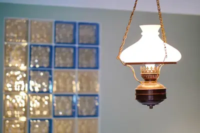 a light hanging from a chain in front of a window at The Bookies Apartments in Sofia