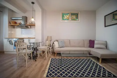 a living room with a couch and a table at The Bookies Apartments in Sofia
