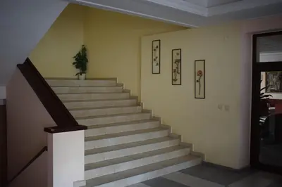 a staircase in a building with a potted plant at Hotel Jeravna in Bankya