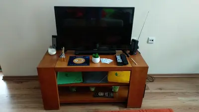 a wooden table with a television on top of it at Pine Tree Apartment D34 in Bansko