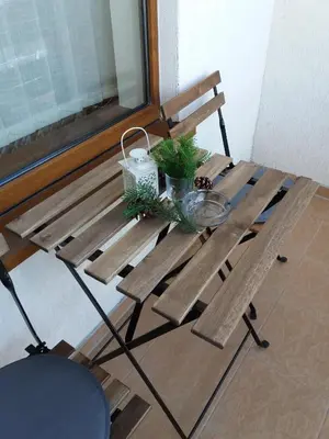 a wooden bench with a table with plants on it at Pine Tree Apartment D34 in Bansko
