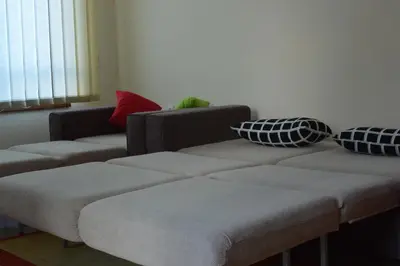 a living room with two couches and pillows at Pine Tree Apartment D34 in Bansko