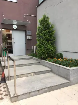 a group of stairs in front of a building with a tree at Deluxe Studio Studentski Grad in Sofia