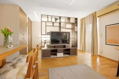 a living room with a television and a table at Deluxe Studio Studentski Grad in Sofia
