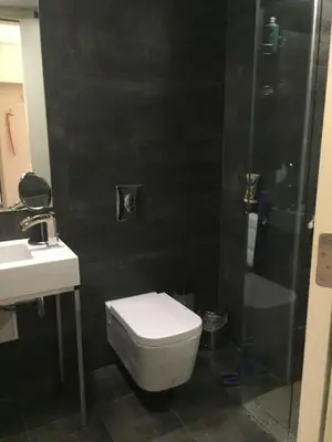 a bathroom with a toilet and a shower and a sink at Deluxe Studio Studentski Grad in Sofia