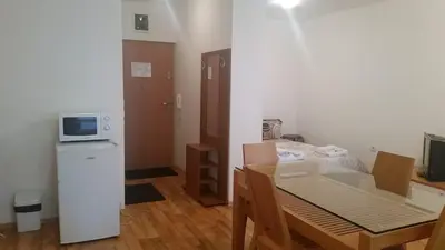 a small room with a table and a microwave at Mountain View A23 in Bansko