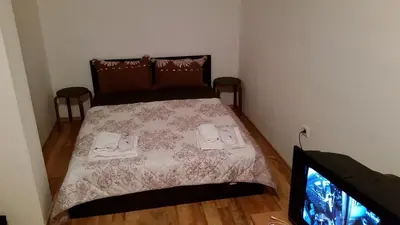 a small bedroom with a bed with a television at Mountain View A23 in Bansko
