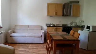 a living room with a couch and a table and a kitchen at Mountain View A23 in Bansko