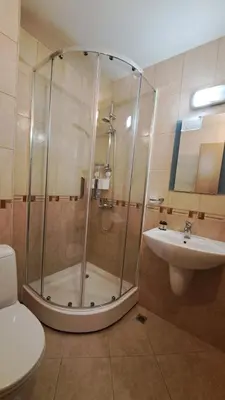 a bathroom with a shower and a toilet and a sink at Mountain View A23 in Bansko