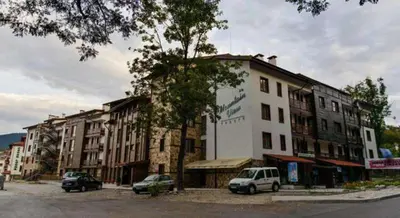 a building with cars parked in front of it at Mountain View A23 in Bansko
