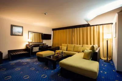 a living room with a couch and a table at Grand Hotel Hebar in Pazardzhik
