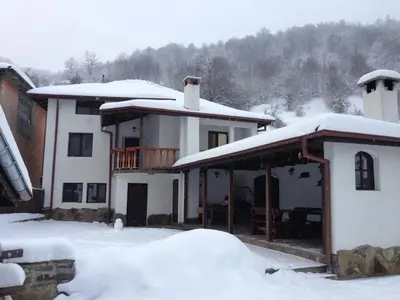 a house with snow on the roof of it at Yovkovata Kyshta in Chiflik