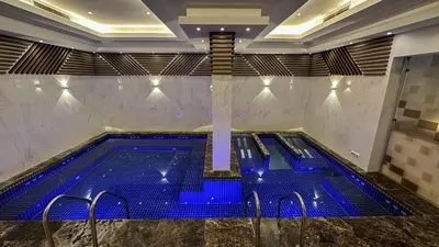 a swimming pool with blue lights in a building at SPA Hotel Ismena in Devin