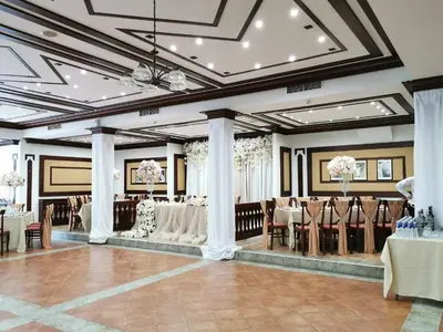 a banquet hall with white tables and chairs at SPA Hotel Ismena in Devin