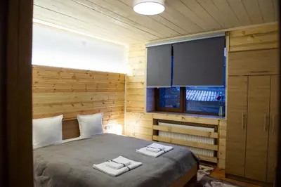 a bedroom with a bed with two towels on it at Sapareva Kashta in Sapareva Banya