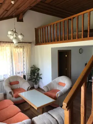 a living room with two chairs and a table at Daf Trans Hotel in Peshtera