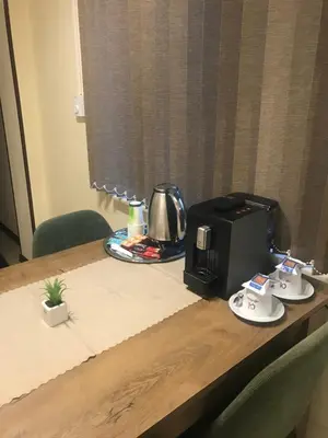 a table with a coffee maker and a toaster on it at Sofia Family House - Free Parking in Sofia