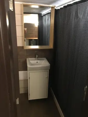 a bathroom with a sink and a mirror at Sofia Family House - Free Parking in Sofia