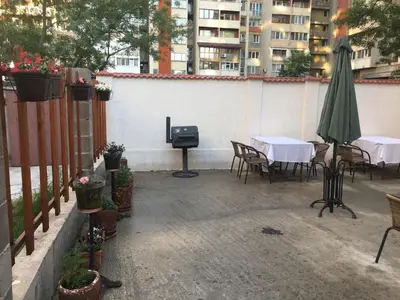 a patio with a table and chairs and a grill at Sofia Family House - Free Parking in Sofia