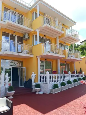 a large yellow building with balconies and plants at Hotel Dalia - Bankya in Bankya
