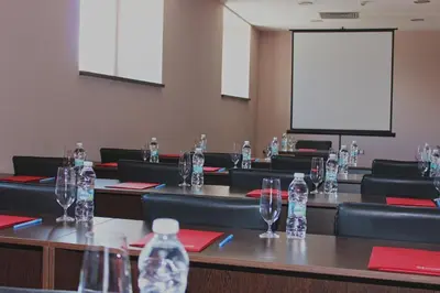 a conference room with bottles of water on tables at Kendros Hotel in Plovdiv