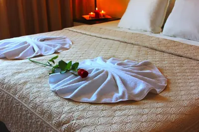 a hotel room with two towels on a bed at Kendros Hotel in Plovdiv