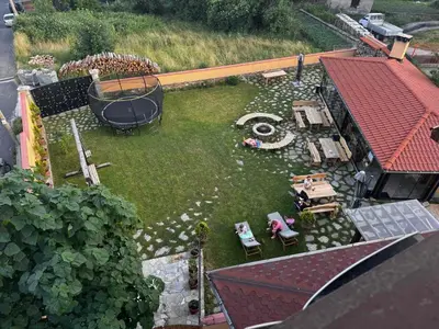 a model of a backyard with a pond and a house at Guesthouse Nefertiti in Smolyan