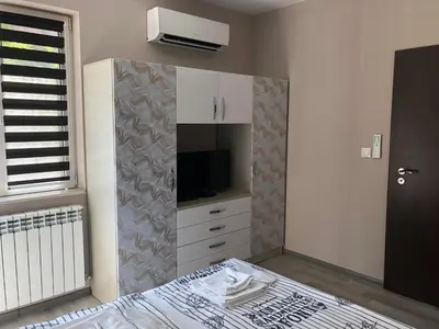a bedroom with a bed and a tv on a wall at Apartment Trimontium in Plovdiv